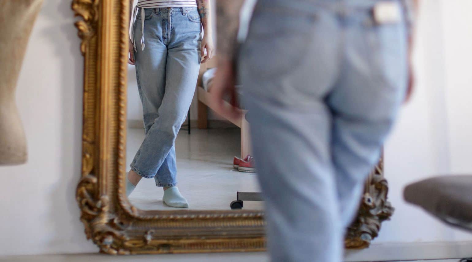 A woman looking at herself in the mirror.