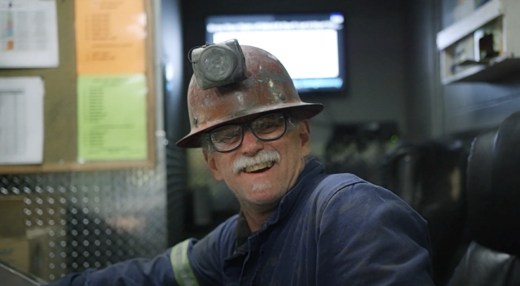A miner smiling