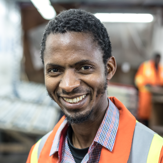Image of male worker smiling.