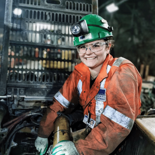 Image of woman fixing machine.