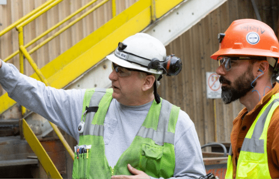 A miner explaining something